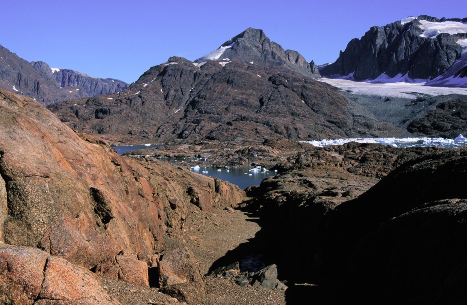 The Skaergaard Intrusion seen across the fjord, with the Basistoppen sill above the layered gabbro
